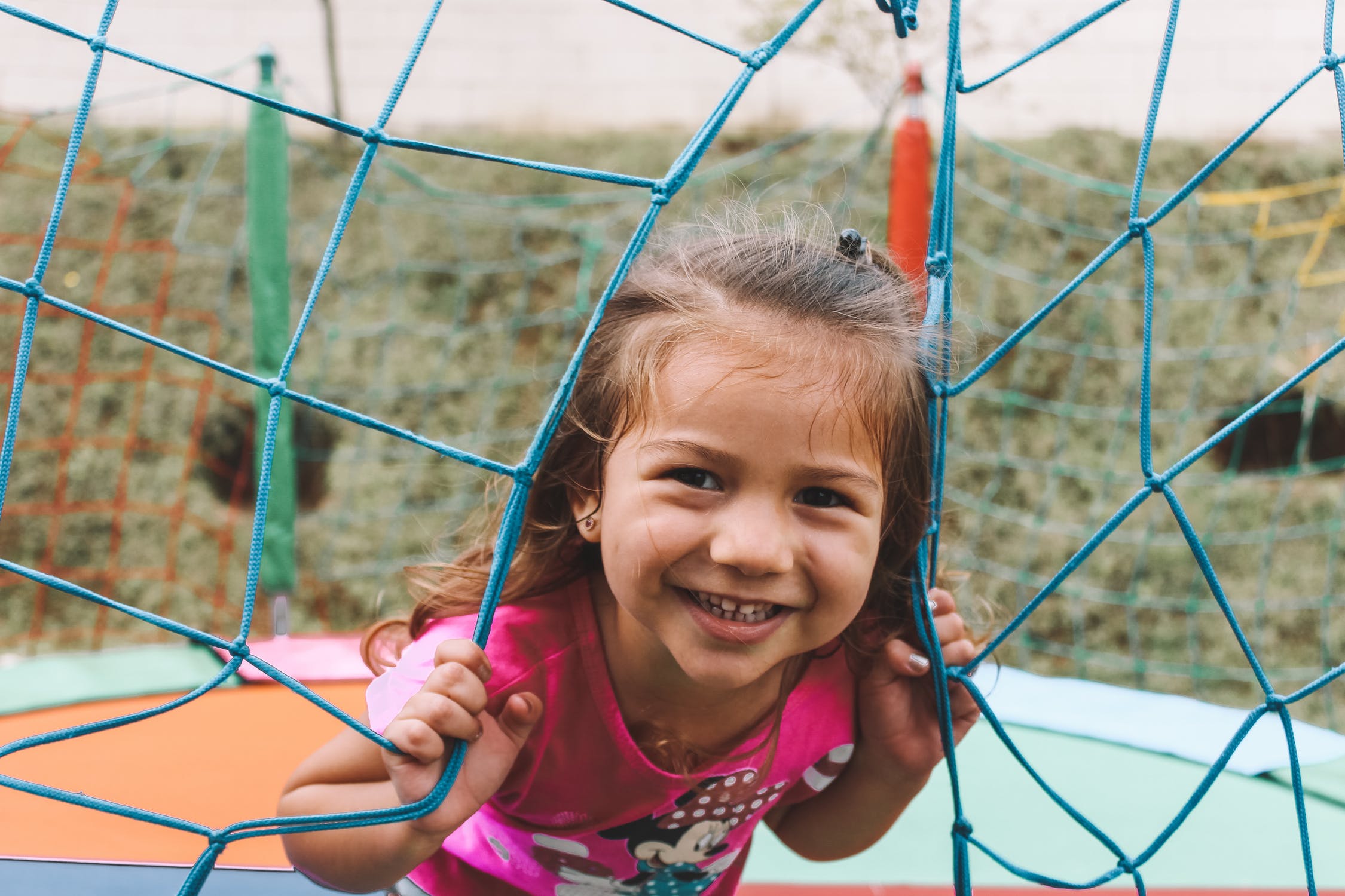 Girl smiling from a climbing frame