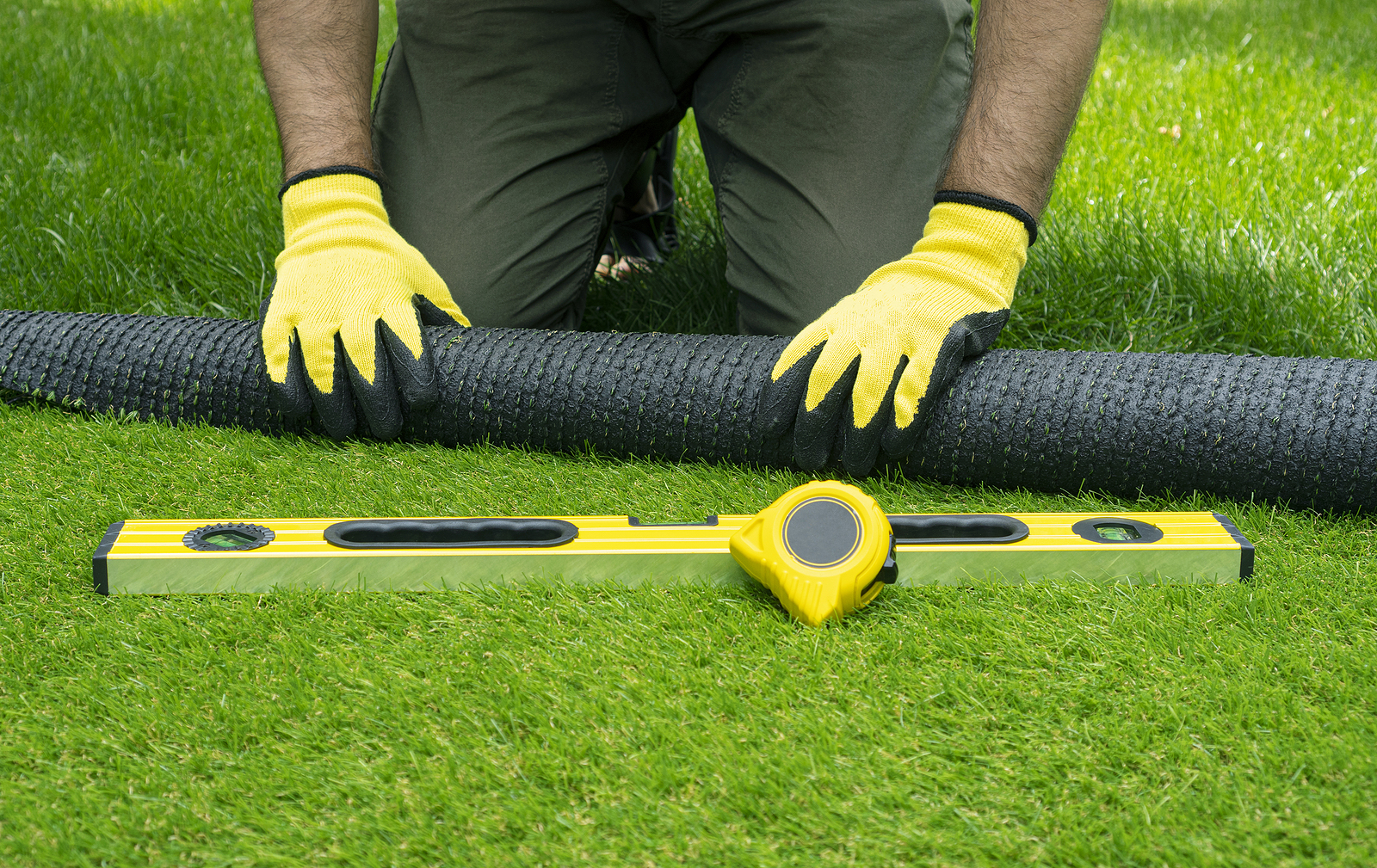 Contractor installing artificial grass